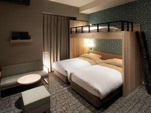 Un pat sau paturi într-o cameră la Kotohira Park Hotel