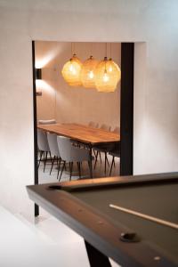 a dining room with a table and chairs in a mirror at Andermatt Alpine Apartments in Andermatt