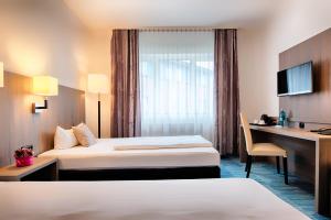 Postel nebo postele na pokoji v ubytování ACHAT Hotel Bochum Dortmund + 28 fotografií