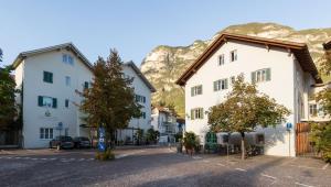 eine Straße in einer Stadt mit Bergen im Hintergrund in der Unterkunft Hotel Teutschhaus in Kurtinig an der Weinstraße