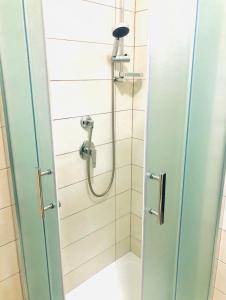 a shower in a bathroom with a glass door at Hotel La Primula in Corigliano Calabro