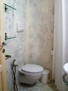 a bathroom with a white toilet and a sink at Casa Agave - villetta sul mare a Salina, Isole Eolie in Malfa