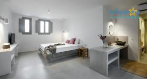 a white bedroom with a bed and two sinks at Antiparos Homes in Antiparos +37 photos