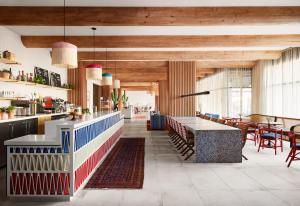 a restaurant with wooden ceilings and tables and chairs at Graduate Tucson in Tucson