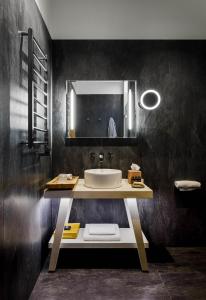 a bathroom with a sink and a mirror at Moss Boutique Hotel in Moscow