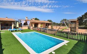 a house with a swimming pool and a playground at Finca Son Sitges 139 by Mallorca Charme in Llubí