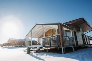 a cabin in the snow with a glass roof at Gorki Golf Resort in Gorki