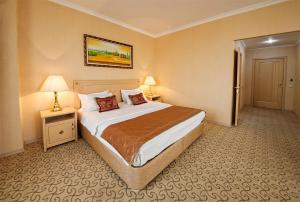 a bedroom with a large bed in a hotel room at Sunflow Park Hotel in Kartmazovo