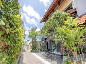 a street with plants on the side of a building at Paradise Inn in Legian
