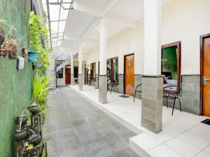 an empty hallway with tables and chairs in a building at Paradise Inn in Legian