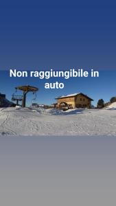 a house on top of a snow covered hill at Rifugio Col de Varda in Misurina