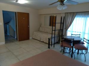 a living room with a couch and a table at Maison Apart Hotel in Mar del Plata