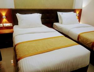 Postel nebo postele na pokoji v ubytování Hotel Laxmi Cityside