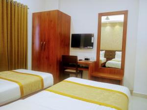 Postel nebo postele na pokoji v ubytování Hotel Laxmi Cityside