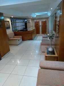 a lobby with couches and a vase of flowers at Maison Apart Hotel in Mar del Plata