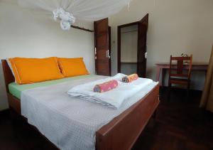 a bedroom with a bed with two pillows on it at Ruby - Casa de Hospedes - Backpackers in Nampula