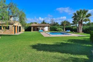 a yard with a swimming pool and a house at 041 Finca Can Roig Gran ET0309 by Mallorca Charme in Pollença
