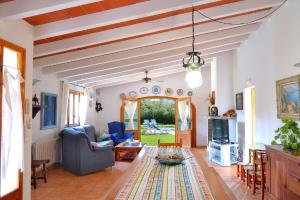 a living room with a couch and a table at Finca Can Roig Gran 041 by Mallorca Charme in Pollença