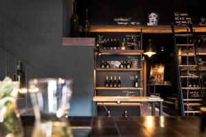 a bar with bottles of wine on a shelf at Hotel / Weingut Meintzinger in Frickenhausen