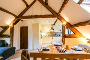 a kitchen and dining room with a table and chairs at Cwm Chwefru Holiday Cottages in Llanafan-fawr