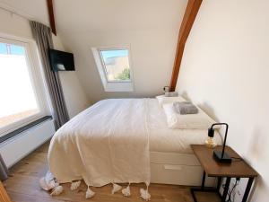 A bed or beds in a room at Luxurious historical Loft close to the beach!