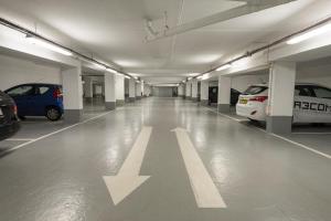 an empty parking garage with an arrow on the floor at Holiday Inn Express Paris - Velizy, an IHG Hotel in Vélizy-Villacoublay