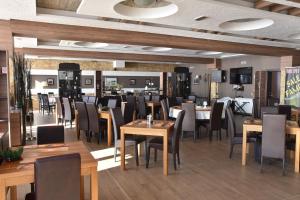 a dining room with tables and chairs in a restaurant at Milmari Apartment 43 Premier Pollo in Kopaonik