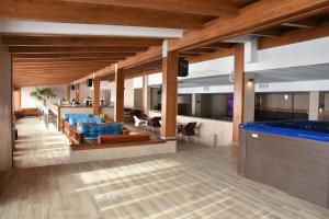 a living room with blue couches and a bar at Milmari Apartment 43 Premier Pollo in Kopaonik