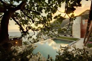 a swimming pool with a view of the ocean at Amore Rentals - Villa Angelina in Positano