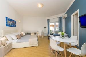 a bedroom with a bed and a table and a tv at Aurelia 429 Fine Town House in Rome