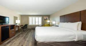 a hotel room with a large bed and a flat screen tv at Best Western Houston Bush IAH Intercontinental Airport Inn in Humble