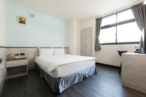 Ένα ή περισσότερα κρεβάτια σε δωμάτιο στο Raise Hotel Taichung