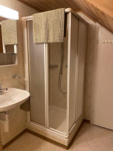 een badkamer met een douche en een wastafel bij Chalet Schönberg in Gunten