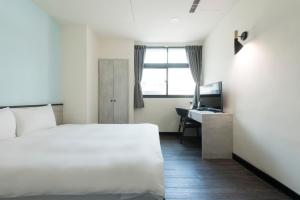 Voodi või voodid majutusasutuse Raise Hotel Taichung toas