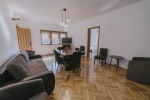 a living room with a couch and a dining room table at Predoi's Place in Sinaia