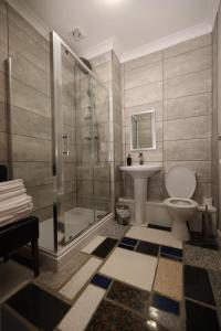 uma casa de banho com um chuveiro, um WC e um lavatório. em Michelangelos - Rooms, Restaurant & Bar em Gateshead