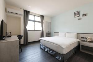 Voodi või voodid majutusasutuse Raise Hotel Taichung toas