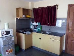 Kuchyň nebo kuchyňský kout v ubytování Kim Suites - Mvuli Studio Apartment