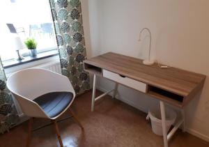 a desk and a chair in a room with a window at STF Kalix Vandrarhem in Kalix