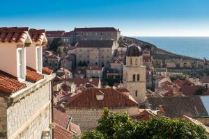 a view of a town with a church and the ocean at Rooms Lavanda&Ruzmarin in Dubrovnik