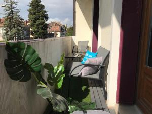 un balcón con 2 sillas y una maceta en LES ÎLES - Parking, Balcon, Netflix & PS4! en Annecy