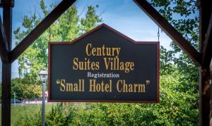 a sign for a small hotel chirm at Century Suites Hotel in Bloomington