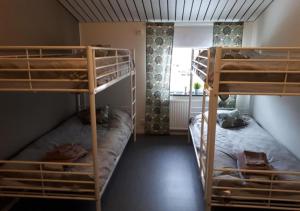 two bunk beds in a room with a window at STF Kalix Vandrarhem in Kalix