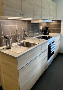 a kitchen with a sink and a stove at STF Kalix Vandrarhem in Kalix