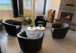 a living room with chairs and a fire place at STF Kalix Vandrarhem in Kalix