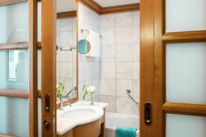 a bathroom with a sink and a mirror at Mitsis Selection Blue Domes in Kardamaina