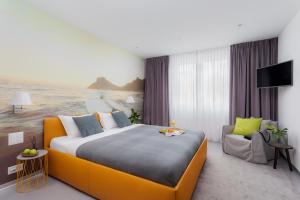 a hotel room with a large bed and a television at VISIONAPARTMENTS Rue des Communaux - contactless check-in in Vevey
