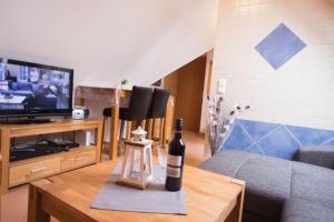 ein Wohnzimmer mit einer Flasche Wein auf dem Tisch in der Unterkunft Haus Celina 1 Zimmer Appartement in Büsum