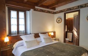 a bedroom with a large bed with two pillows at Garos Ostau in Garós