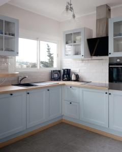 a white kitchen with white cabinets and a sink at 2BDR Reine Astrid in Cannes